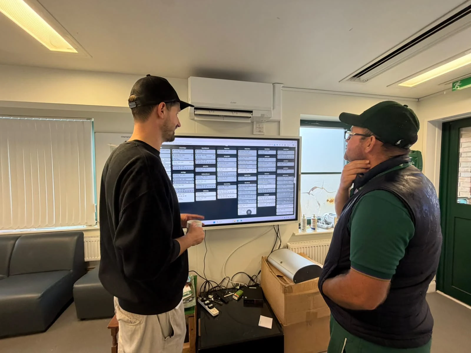 Grounds team members reviewing pitch work together in turfcoach